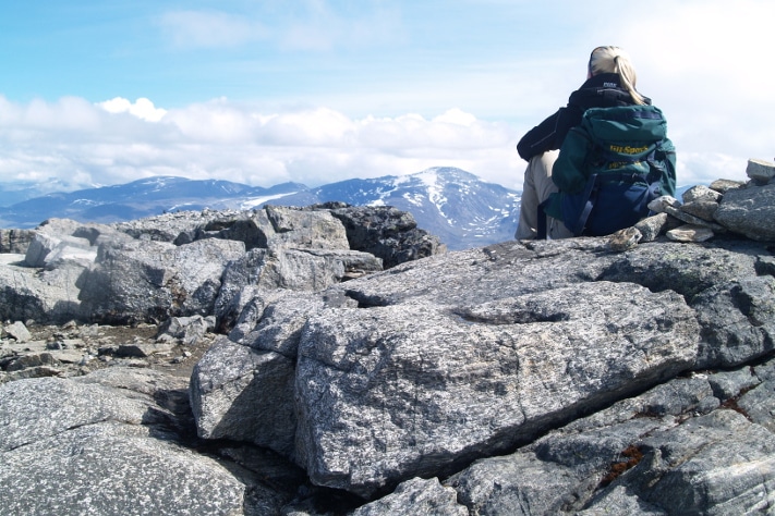 De syv blåner. Fra Keilhaus topp kan vi skue ut over Jotunheimen og en liten flik av den lange rekken av norske fjell som utgjør en sammenhengende kjede. Alpene og Pyreneene har høyere topper, og de to fjellkjedene er langt bedre kjent for sitt spektakulære landskap, men ingen kan ta fra oss at vårt eget land faktisk har Europas lengste fjellkjede. De færreste er klar over dette faktum. Det forklarer kanskje hvorfor den fortsatt ikke har sitt eget navn. Foto: Halfdan Carstens