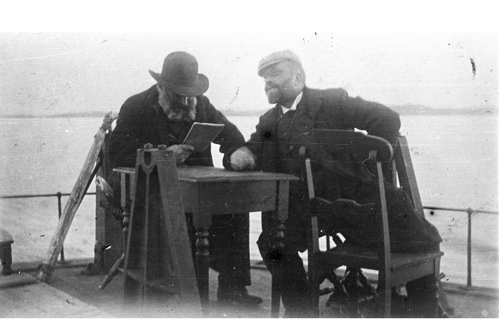Kan hende er de på vei til et politisk møte, de to venstremennene Amund Helland (med bok i hånden) og Viggo Ullmann (1848–1910). Bildet er tatt en gang mellom 1900 og 1919. På det tidspunktet var Ullmann, som opprinnelig var skolemann, stortingsrepresentant for Venstre. Foto: Museum for universitets- og vitenskapshistorie, Universitetet i Oslo.